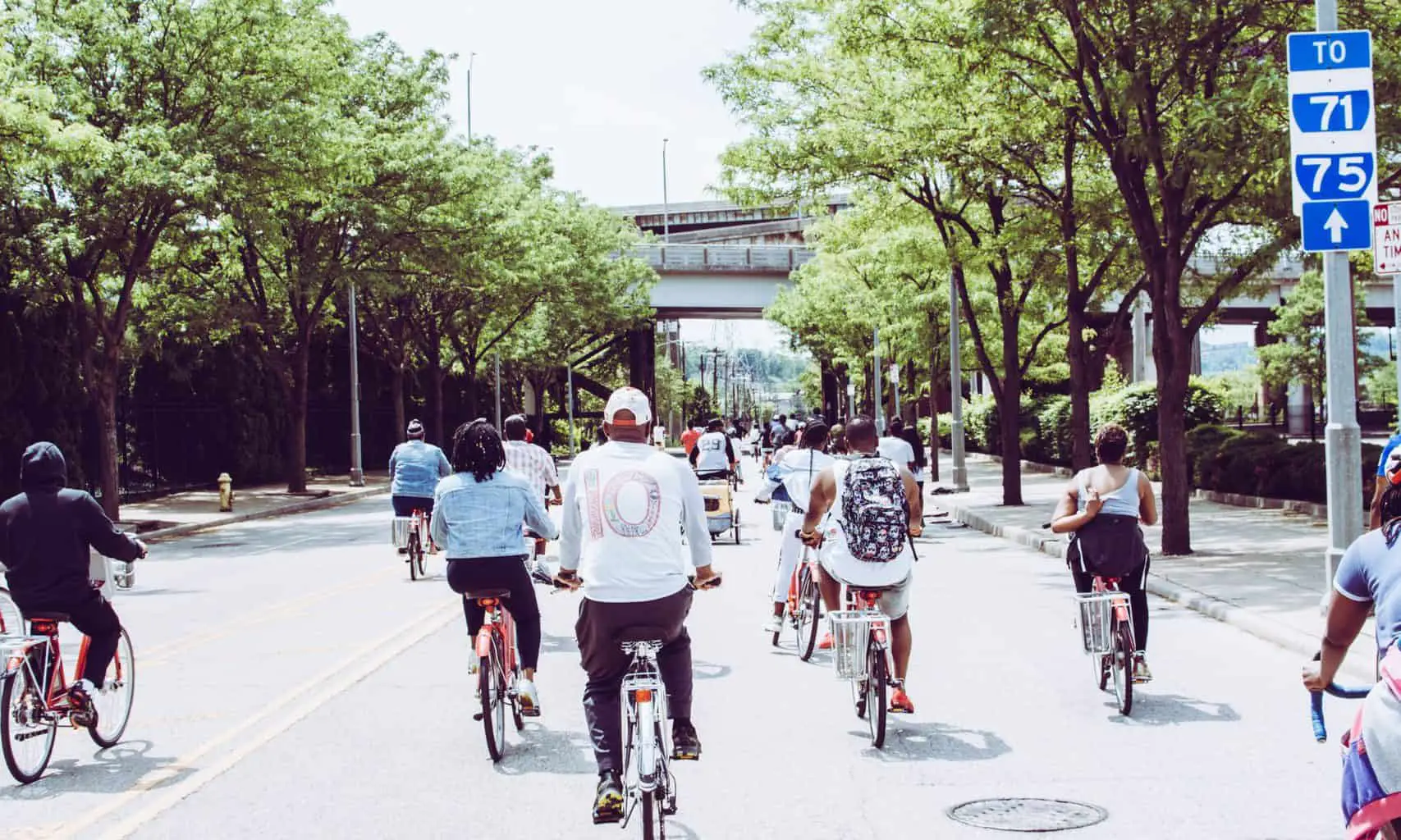 people riding bicycle on concrete road